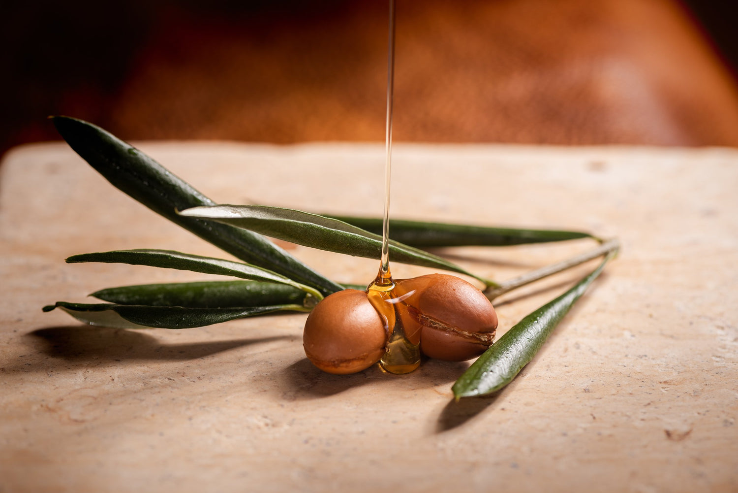 Argan seeds with Argan oil dripping over 