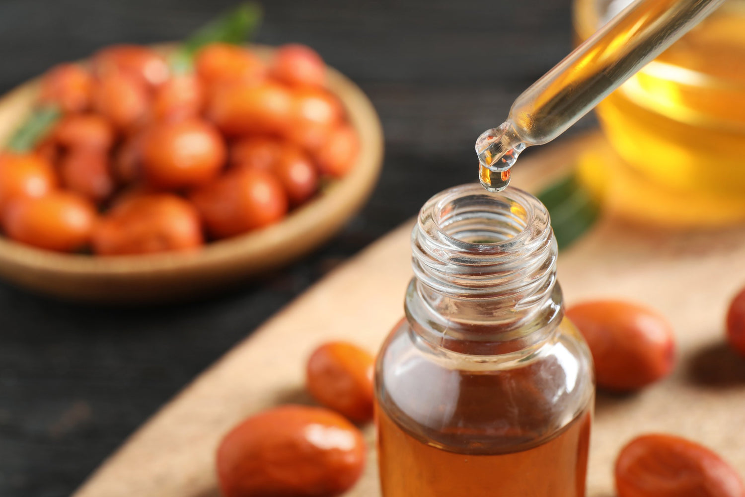 Jojoba oil inside a bottle with a dropper 